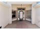 Inviting front porch with a stylish light fixture and decorative trim around the front door and windows at 2461 Merida Cir, The Villages, FL 32162