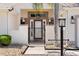 Close-up of a gated front entrance, showcasing the decorative lighting and well-maintained landscaping at 2461 Merida Cir, The Villages, FL 32162