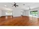 Bright living room featuring hardwood floors, a ceiling fan, and sliding glass doors at 2461 Merida Cir, The Villages, FL 32162