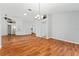An expansive living room featuring hardwood floors, modern lighting, and an open floor plan at 2461 Merida Cir, The Villages, FL 32162