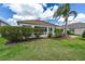 Nicely landscaped backyard with manicured lawn, paver patio, mature palm tree, and well-maintained greenery at 278 Matisse Ave, The Villages, FL 32162