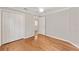 Bright bedroom features hardwood floors, ceiling fan, and closet with folding doors at 278 Matisse Ave, The Villages, FL 32162