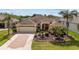 Beautiful single-Gathering home featuring mature landscaping, brick driveway, and a spacious two-car garage at 278 Matisse Ave, The Villages, FL 32162