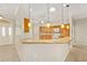 Open kitchen featuring a breakfast bar with granite countertops, wood cabinetry, and tile flooring at 278 Matisse Ave, The Villages, FL 32162