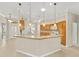 Spacious kitchen featuring a breakfast bar, tile flooring, wood cabinets, and pendant lighting at 278 Matisse Ave, The Villages, FL 32162