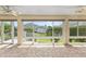 Screened lanai with brick flooring, ceiling fans, and expansive backyard views at 278 Matisse Ave, The Villages, FL 32162