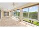 Screened lanai featuring brick flooring, ceiling fans and backyard views at 278 Matisse Ave, The Villages, FL 32162