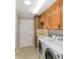 Laundry room featuring washer and dryer, utility sink and storage cabinets at 278 Matisse Ave, The Villages, FL 32162