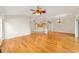 Open living area with hardwood flooring connecting the living room, dining area, and kitchen space at 278 Matisse Ave, The Villages, FL 32162