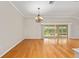 Bright living room featuring hardwood floors, chandelier, and sliding glass doors leading to outdoor space at 278 Matisse Ave, The Villages, FL 32162