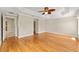 Spacious main bedroom featuring hardwood floors, tray ceiling, and access to walk-in closet and ensuite at 278 Matisse Ave, The Villages, FL 32162