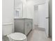 Bathroom showcases a toilet, vanity with storage and a doorway leading to another room at 28078 Poppy Ct, Leesburg, FL 34748