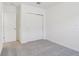 This bedroom features neutral carpeting and a closet with sliding doors at 28078 Poppy Ct, Leesburg, FL 34748