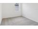 Bright bedroom with neutral carpet, window, and natural light at 28078 Poppy Ct, Leesburg, FL 34748