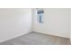This bedroom includes carpet, a window for natural light, and neutral wall paint at 28078 Poppy Ct, Leesburg, FL 34748