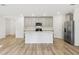 Kitchen featuring a center island, stainless steel appliances, and gray cabinets at 28078 Poppy Ct, Leesburg, FL 34748