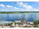 Aerial view showcases lakefront dining on docks, surrounded by lush landscapes and sparkling waters, creating a serene atmosphere at 299 Jefferson Ln, The Villages, FL 32162