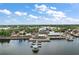 Scenic aerial shot of waterfront buildings with docks along a lake, showcasing the vibrant community and picturesque views at 299 Jefferson Ln, The Villages, FL 32162