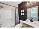Nicely appointed bathroom features modern fixtures, tub/shower, and tiled accent wall at 299 Jefferson Ln, The Villages, FL 32162