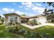 Charming single-story home with well-manicured lawn and colorful landscaping on a sunny day at 299 Jefferson Ln, The Villages, FL 32162