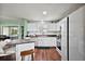 Bright kitchen features white cabinets, wood countertops, stainless steel appliances, and modern island at 299 Jefferson Ln, The Villages, FL 32162