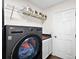Modern laundry room with high-efficiency washer/dryer, cabinets, and a butcher block countertop at 299 Jefferson Ln, The Villages, FL 32162