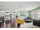 Open concept living room with hardwood floors, seamlessly connected to kitchen and dining at 299 Jefferson Ln, The Villages, FL 32162