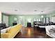 Cozy living room flows to dining space with hardwood floors and lots of natural light at 299 Jefferson Ln, The Villages, FL 32162