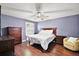 Spacious bedroom features hardwood floors, ceiling fan, window with plantation shutters, and ample closet space at 299 Jefferson Ln, The Villages, FL 32162