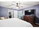 Spacious bedroom featuring hardwood floors, closet, and an ensuite bathroom at 299 Jefferson Ln, The Villages, FL 32162