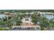 Charming town center featuring landscaped gathering spaces, palm trees, and convenient parking, ideal for community events at 299 Jefferson Ln, The Villages, FL 32162