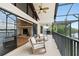 A serene balcony with lake view, rocking chairs, and access to an indoor fireplace, perfect for relaxation at 3011 Lake Woodward Dr, Eustis, FL 32726