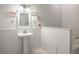 Clean bathroom with a sink, mirror, and decorative accents at 3011 Lake Woodward Dr, Eustis, FL 32726