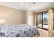 Comfortable bedroom with a sliding glass door leading to a screened patio overlooking the lake at 3011 Lake Woodward Dr, Eustis, FL 32726