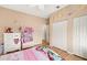 Bedroom with decor and ceiling fan overlooking a double door closet at 3011 Lake Woodward Dr, Eustis, FL 32726