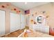 Charming bedroom featuring decor, wall stickers and a double door closet at 3011 Lake Woodward Dr, Eustis, FL 32726