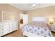 Cozy bedroom featuring a dresser, nightstand, and doorway to other parts of the house at 3011 Lake Woodward Dr, Eustis, FL 32726