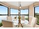 Cozy breakfast nook with waterfront views and a modern glass-top table setting at 3011 Lake Woodward Dr, Eustis, FL 32726