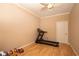 Bright exercise room with a ceiling fan, treadmill, and hardwood floors at 3011 Lake Woodward Dr, Eustis, FL 32726