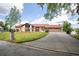 Well-maintained home with an attached garage, lush lawn, and beautiful landscaping at 3011 Lake Woodward Dr, Eustis, FL 32726