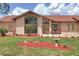 Beautifully landscaped front yard with mature trees and a charming house, creating a welcoming and picturesque curb appeal at 3011 Lake Woodward Dr, Eustis, FL 32726