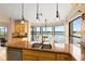 Kitchen featuring custom cabinets, stainless appliances, and beautiful lake views for dining at 3011 Lake Woodward Dr, Eustis, FL 32726