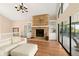 Living room with stone fireplace, built-in shelving and a view of the outdoor patio at 3011 Lake Woodward Dr, Eustis, FL 32726