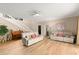 Open concept living room boasts hardwood floors, neutral paint, a piano, and cozy couches for relaxing and entertaining at 3011 Lake Woodward Dr, Eustis, FL 32726