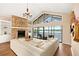 Bright living room features a stone fireplace and a large sliding glass door with lake views at 3011 Lake Woodward Dr, Eustis, FL 32726