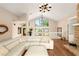 Open concept living room with vaulted ceiling, big windows and cozy seating arrangement at 3011 Lake Woodward Dr, Eustis, FL 32726