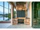 Outdoor patio with stone fireplace, screened in lanai, and hot tub overlooking the lake at 3011 Lake Woodward Dr, Eustis, FL 32726