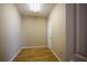 Neutral colored room with wood flooring, a door and electric outlets with a neutral color at 3011 Lake Woodward Dr, Eustis, FL 32726