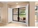 Bright window with white shutters overlooking the lush front yard and providing natural light at 3011 Lake Woodward Dr, Eustis, FL 32726