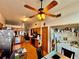 Bright eat-in kitchen featuring wood cabinets, flooring, ceiling fan and adjacent laundry area at 3051 Newmark Dr, Deltona, FL 32738